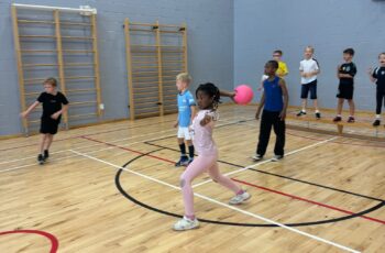 Children playing sport indoors