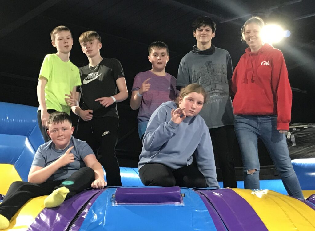 Group of young people in indoor inflatable assault course