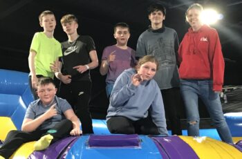 Group of young people in indoor inflatable assault course