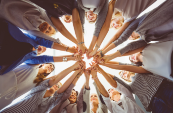 Women's hands joining in a circle