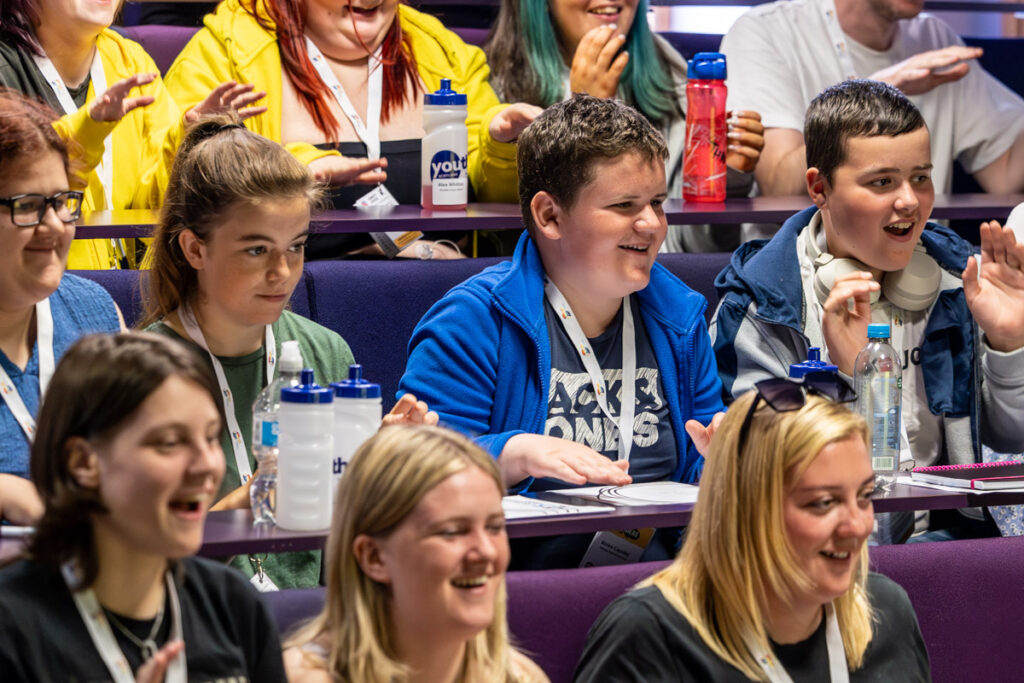 Youth Scotland Generation CashBack Young people smiling in a lecture hall