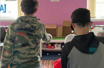 Two young people in activity session indoors
